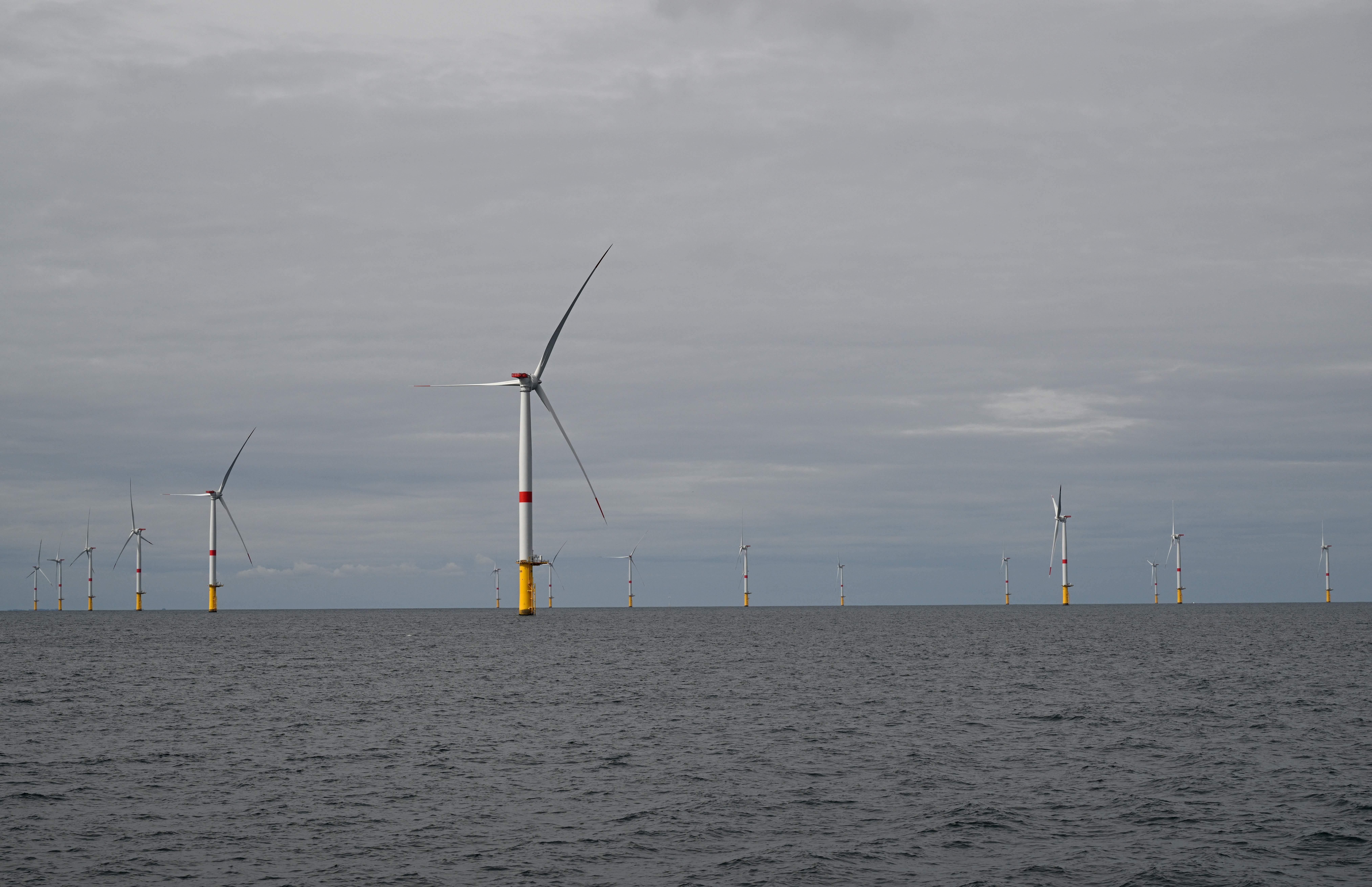 Wind turbines are pictured on the first French offshore wind farm off the coasts of La Turballe, western France on September 30, 2022. – The wind farm, consisting of 80 wind turbines, will supply 480MW, with an investment of 2 billion euros (Photo by Damien MEYER / AFP) (Photo by DAMIEN MEYER/AFP via Getty Images) 