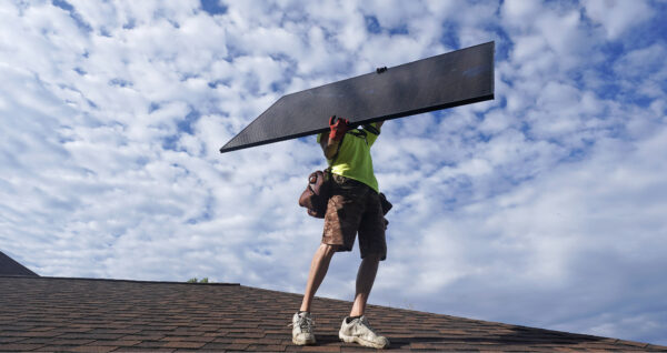 Workman installing solar panels