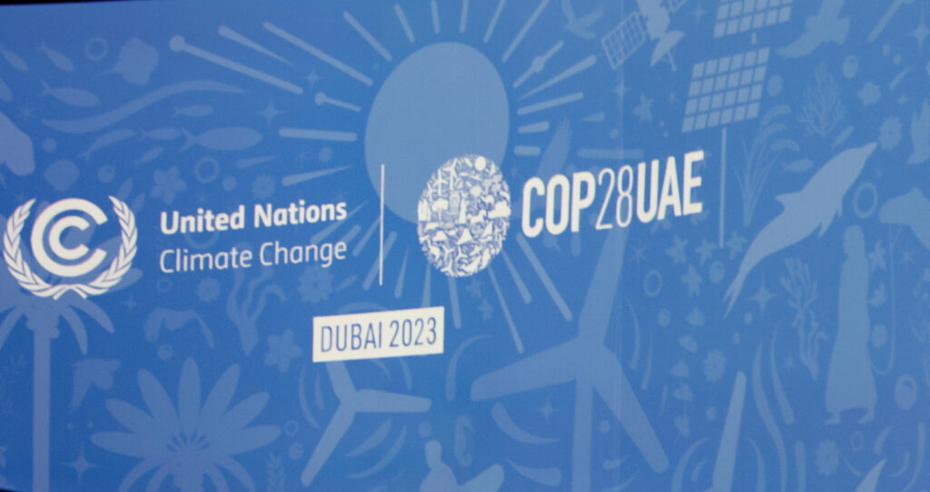 COP28 signage blue background