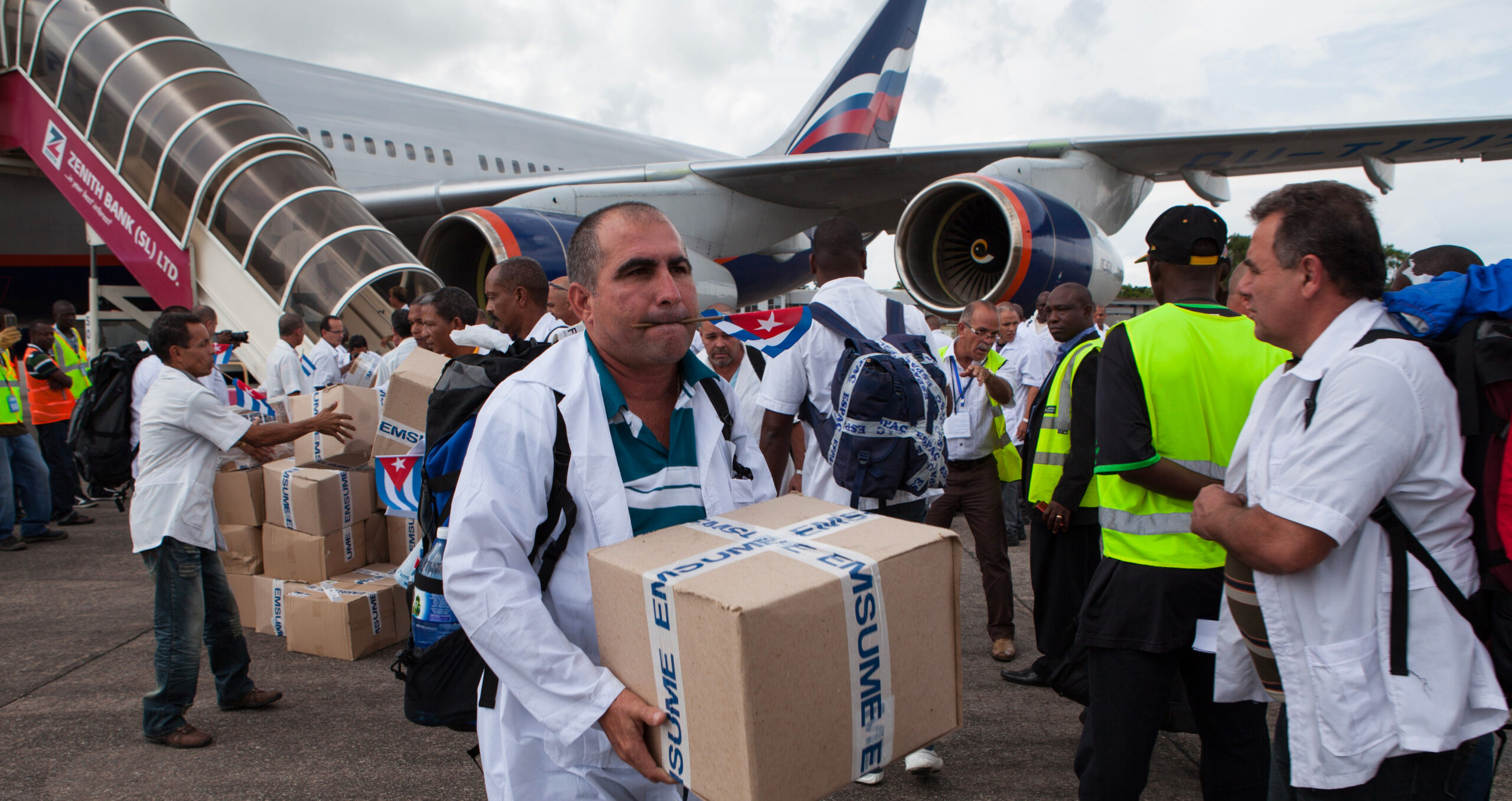 Cuban medical staff arrive in Africa during the Ebola breakout. Global south countries are cooperating to ensure the economic benefits of progressing towards the SDGs benefit the countries in most need of expertise.
(Photo: Florian Plaucheur/AFP via Getty Images) 