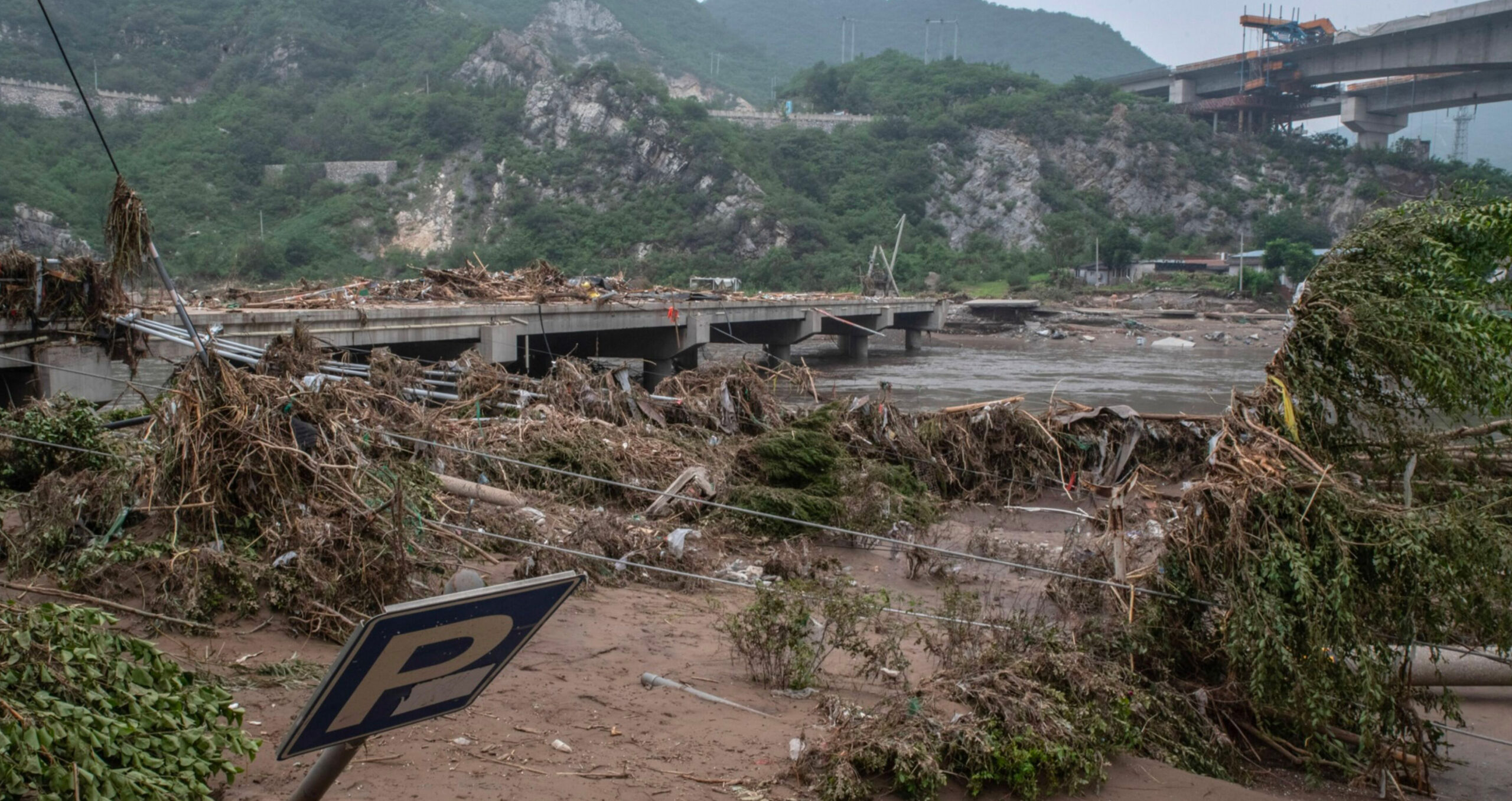 Record floods wash away a bridge in China. PwC found only 47 per cent of CEOs had adapted their businesses  by, for example, ensuring their supply chains are protected from climate-linked disasters. (Photo: Bloomberg) 