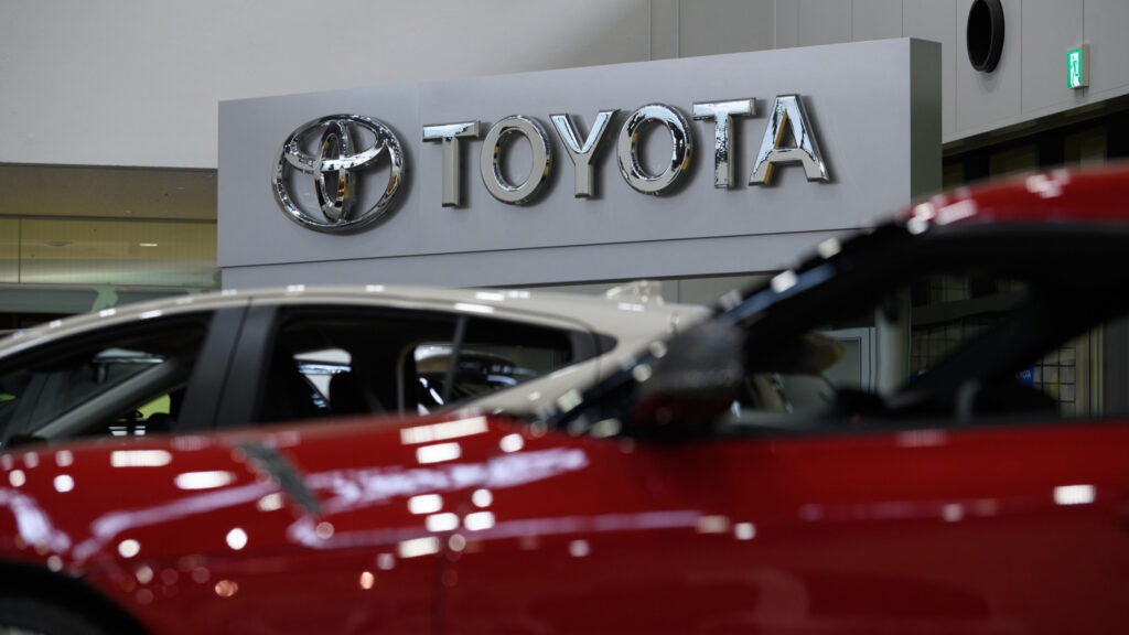 Toyota cars in showroom and logo