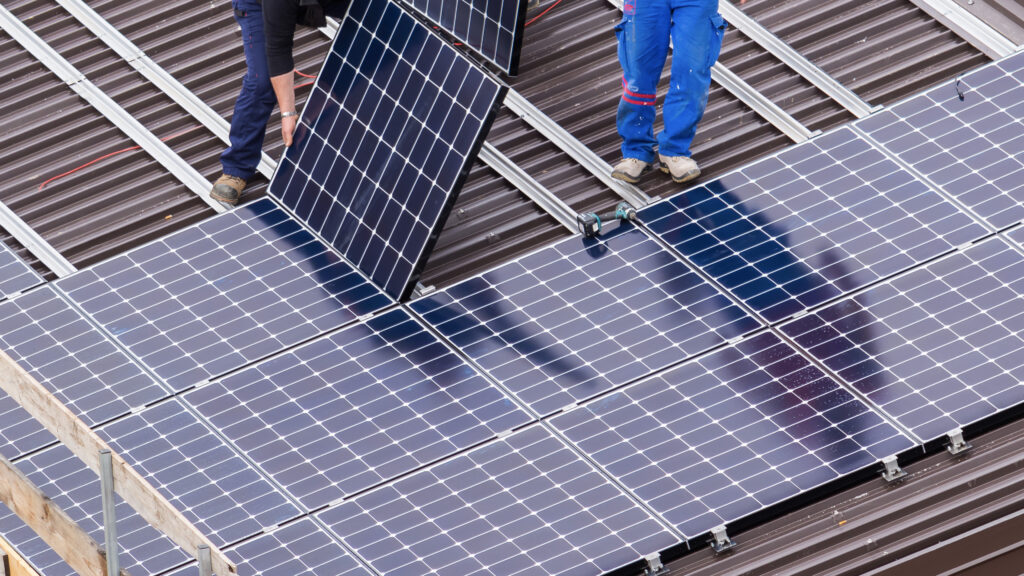 Workers installing solar panels
