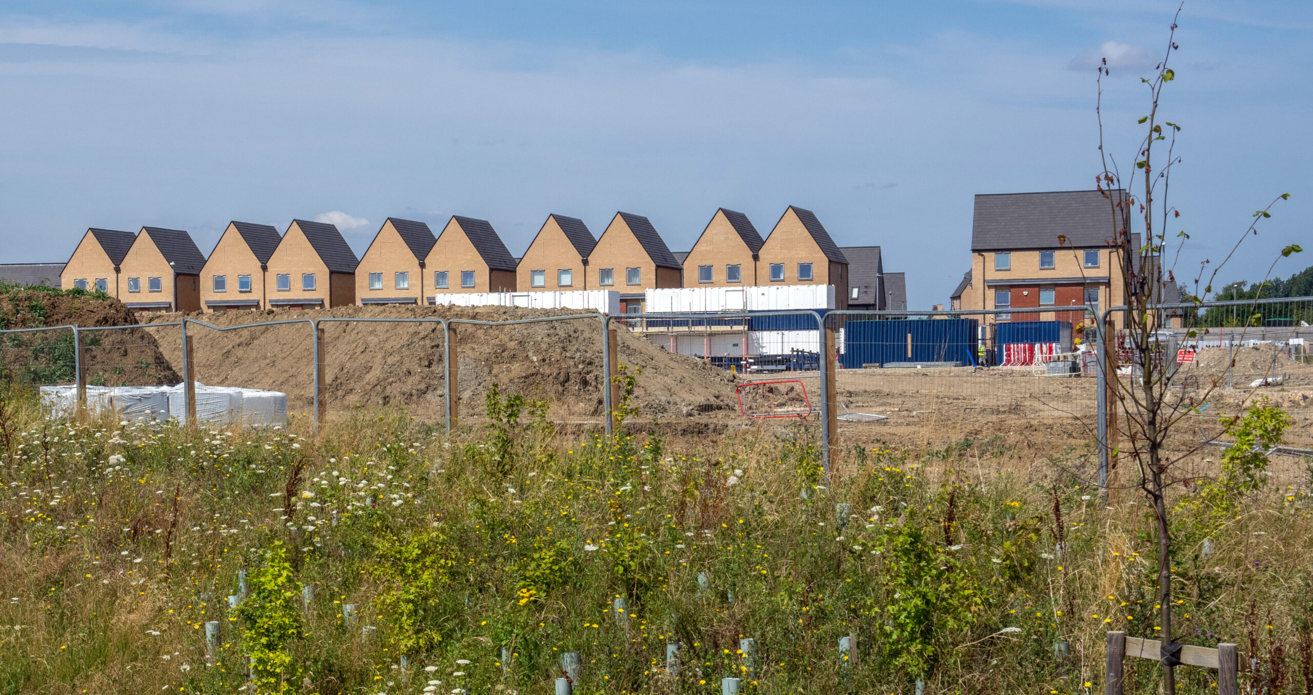 Newly built houses in Cambridgeshire, England. The BNG rules oblige developers to leave sites with better biodiversity than when they began operations, as measured in terms of biodiversity “units” that consider the size of a habitat, its ecological importance and its condition. (Photo: Carl Court/Getty Images) 
