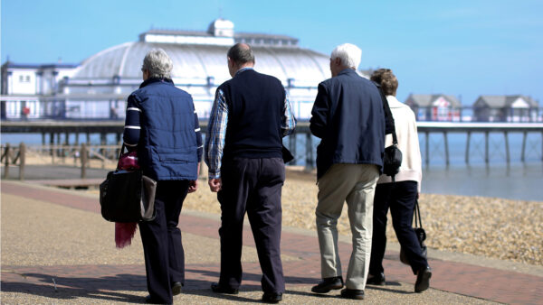 Pensioners walking Eastbourne Pier UK