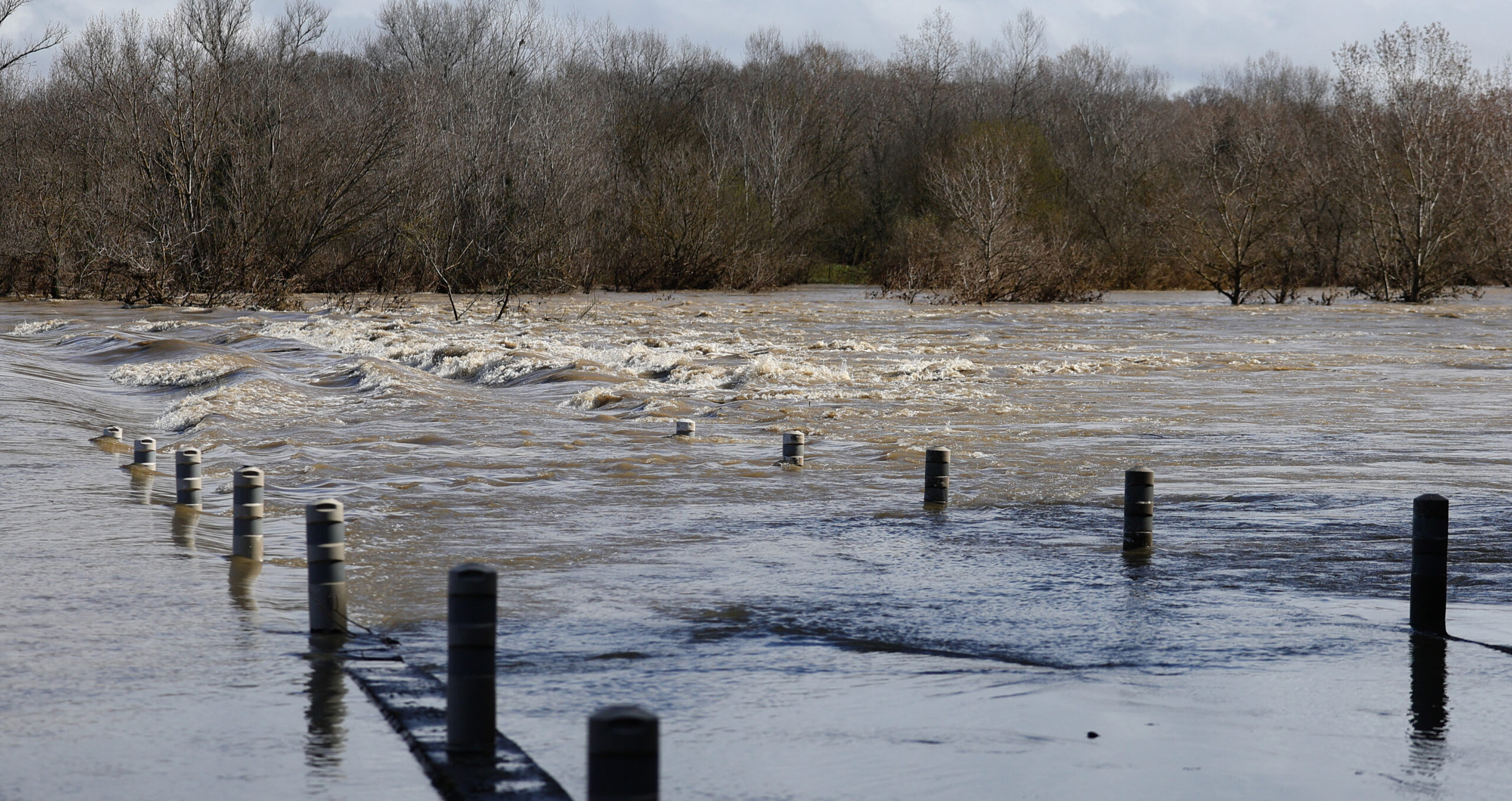 A bridge disappears under the river Gard, following recent heavy storms in  France. The EU is discussing how to finance climate resilience. (Photo: Clement Mahoudeau/AFP via Getty Images) 